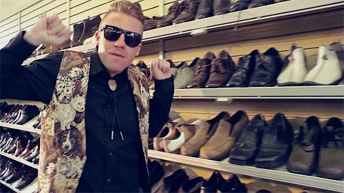 GIF of Macklemore running past shoes in a store