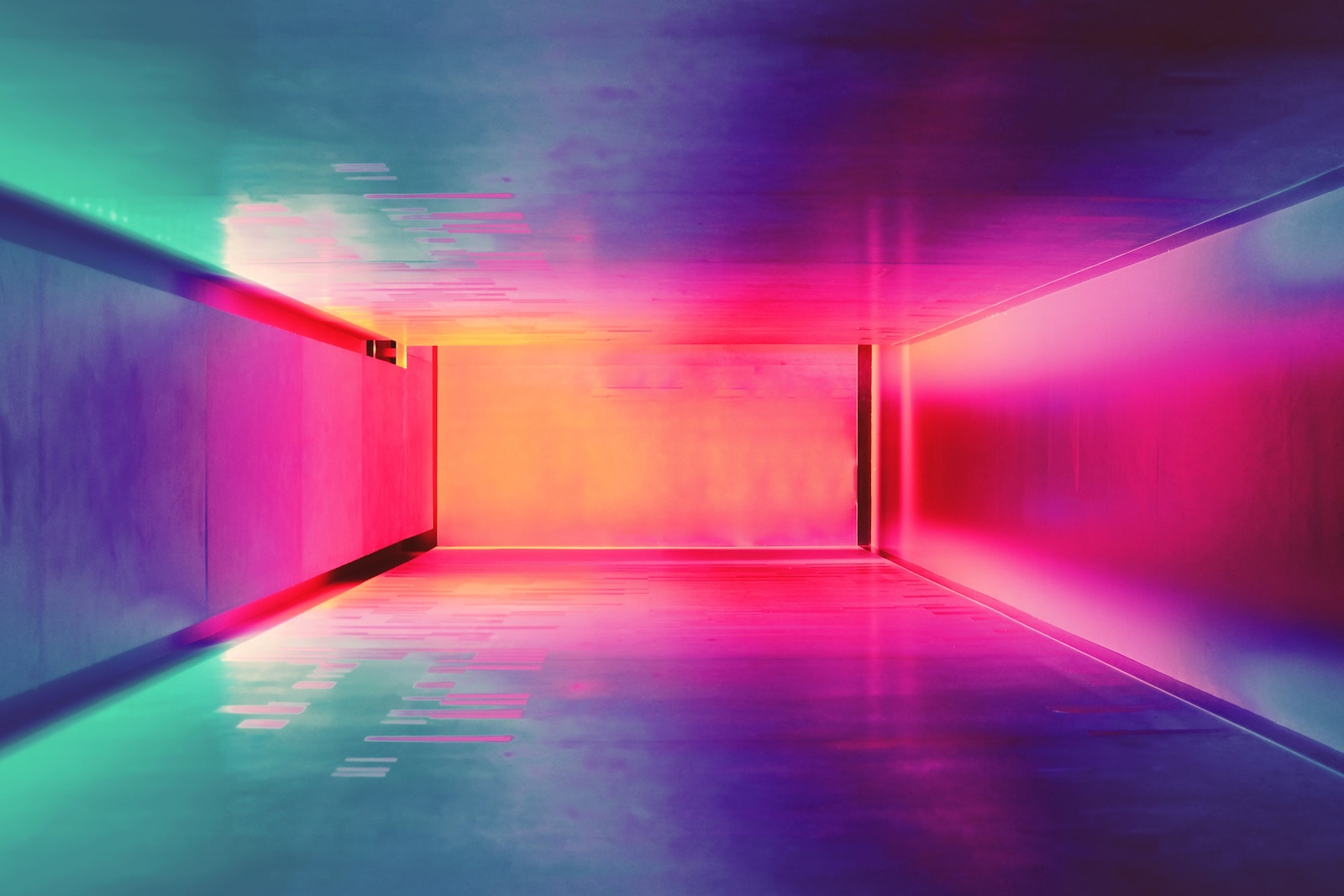 Hallway covered in soft colorful light creating a pink and teal gradient.