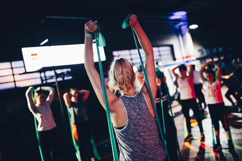 group of people working out with a fitness instructor