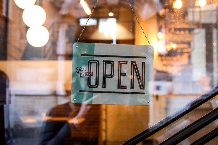 sign in store window that reads open