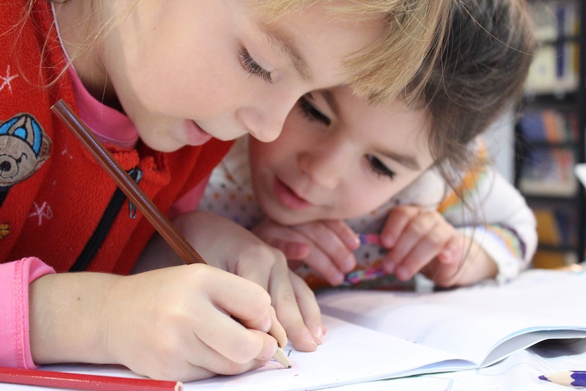 two kids drawing together