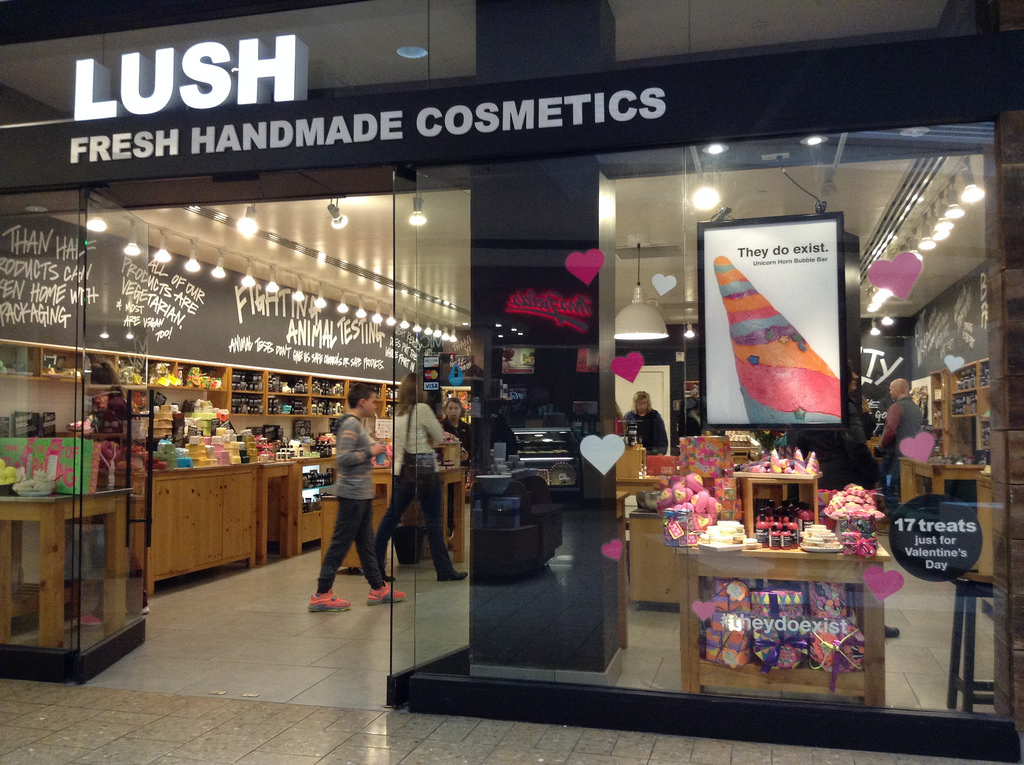 photo of Lush Cosmetics storefront with messages about their values on walls
