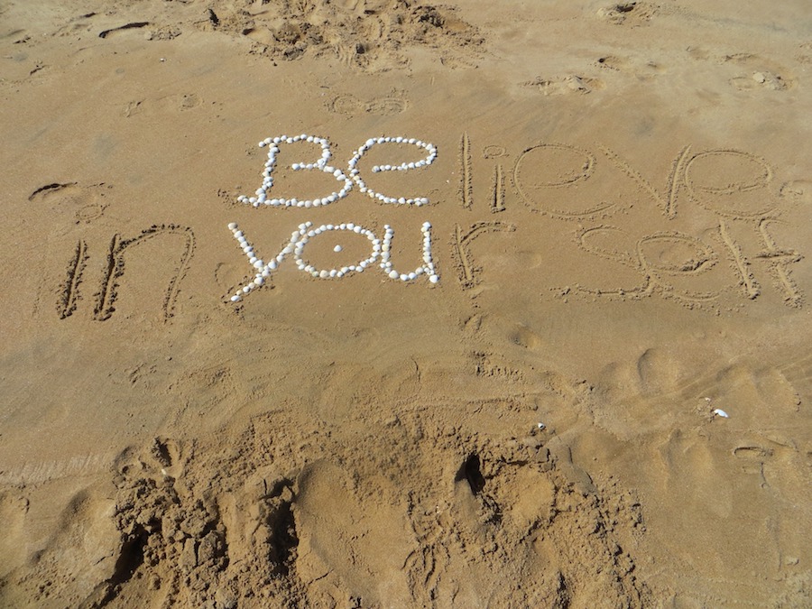 sand with message written in stones