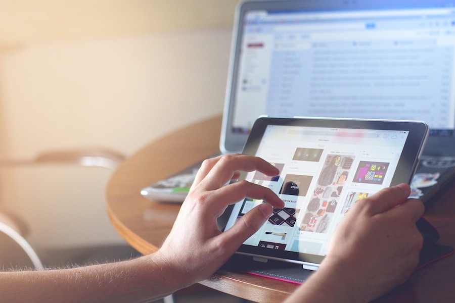 person looking through products on tablet