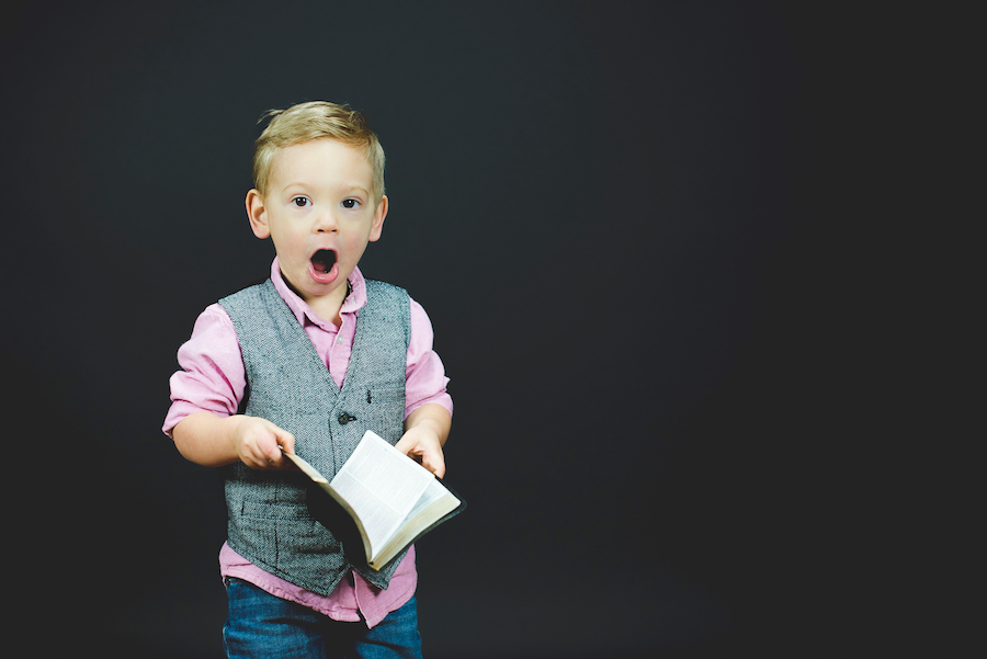 shocked boy holding book