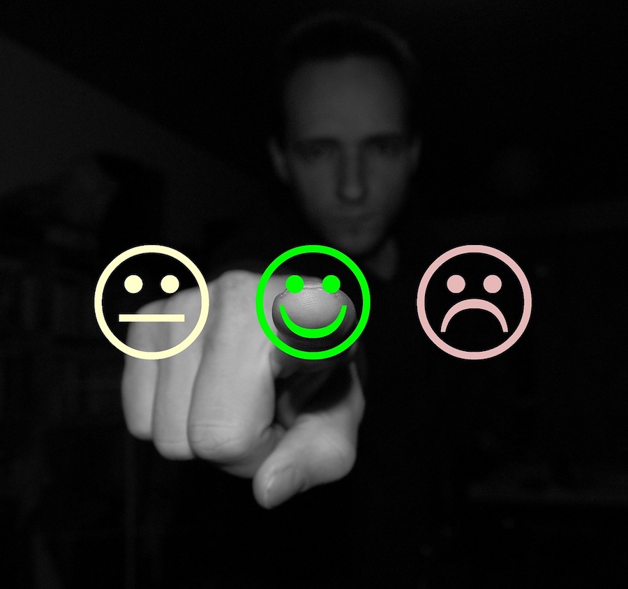 man pointing at positive smiley face