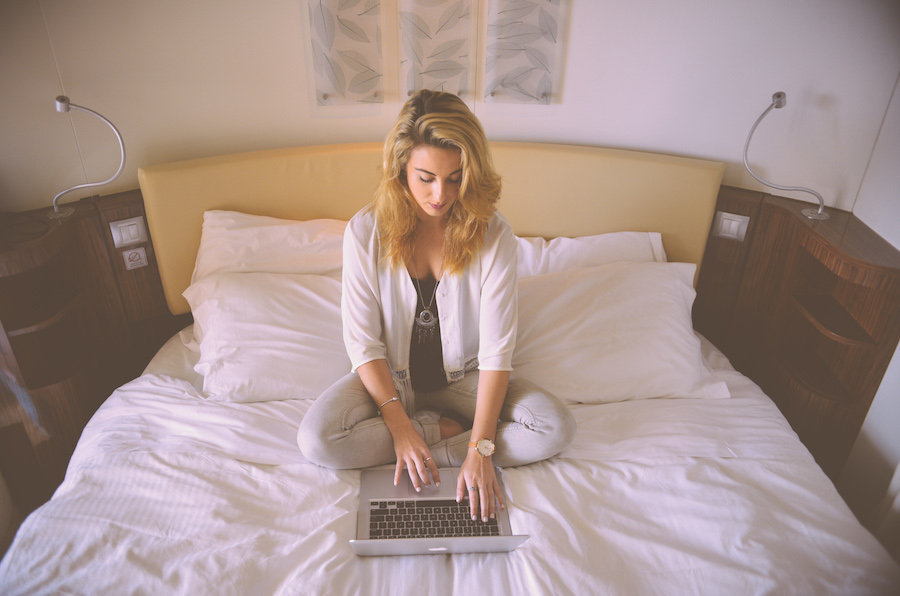 woman on laptop in bed