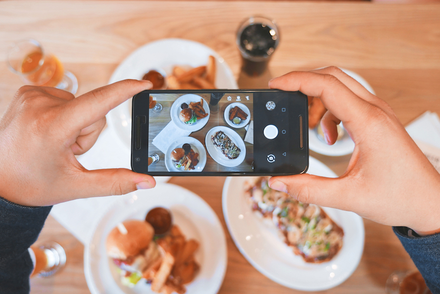 person taking photo of food