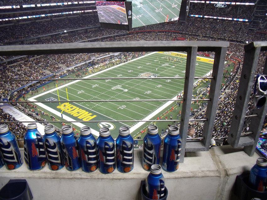 birds eye view of the super bowl game with empty beer cans on the railing