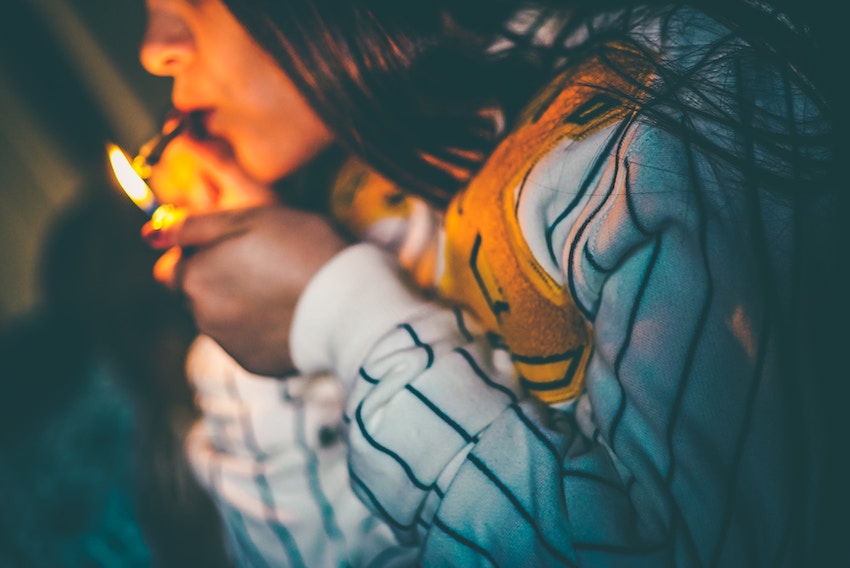 woman lighting a joint