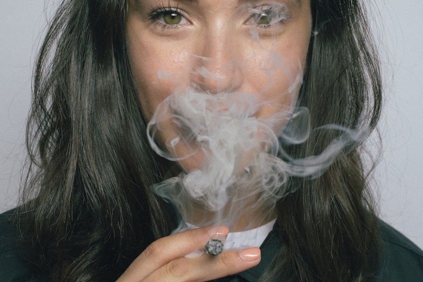 woman smoking a joint and smiling