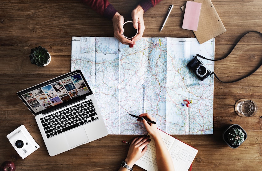 group of people planning route on map