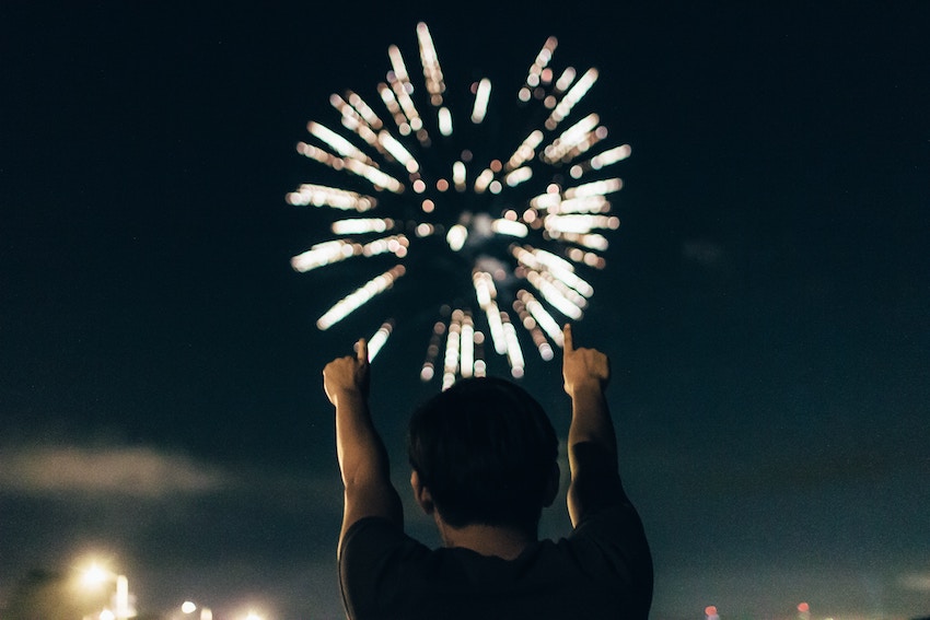 man pointing at fireworks