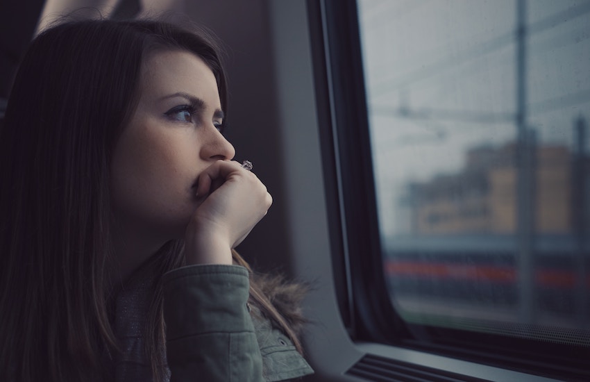 woman staring out window