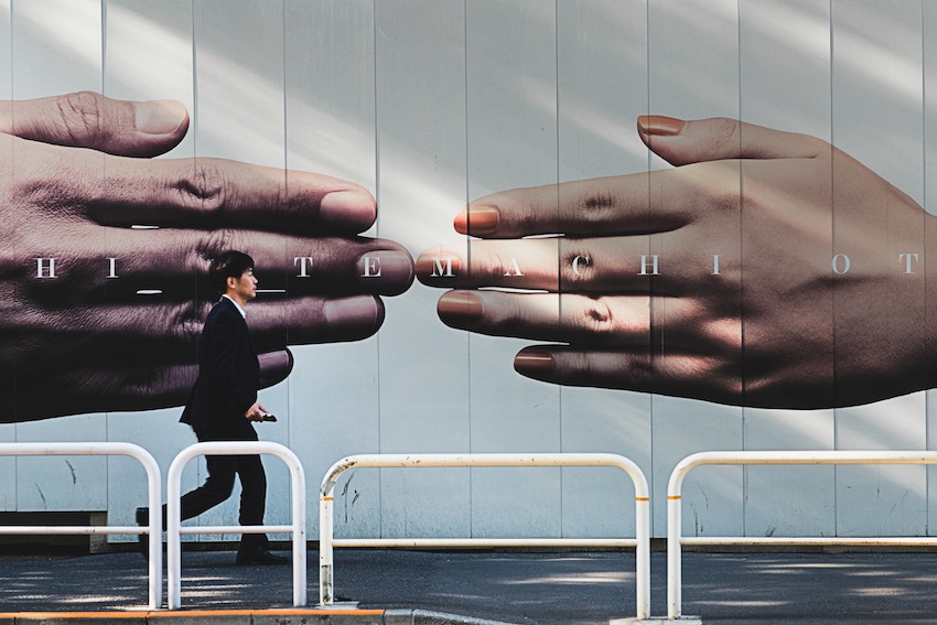 man walking past giant advertisement