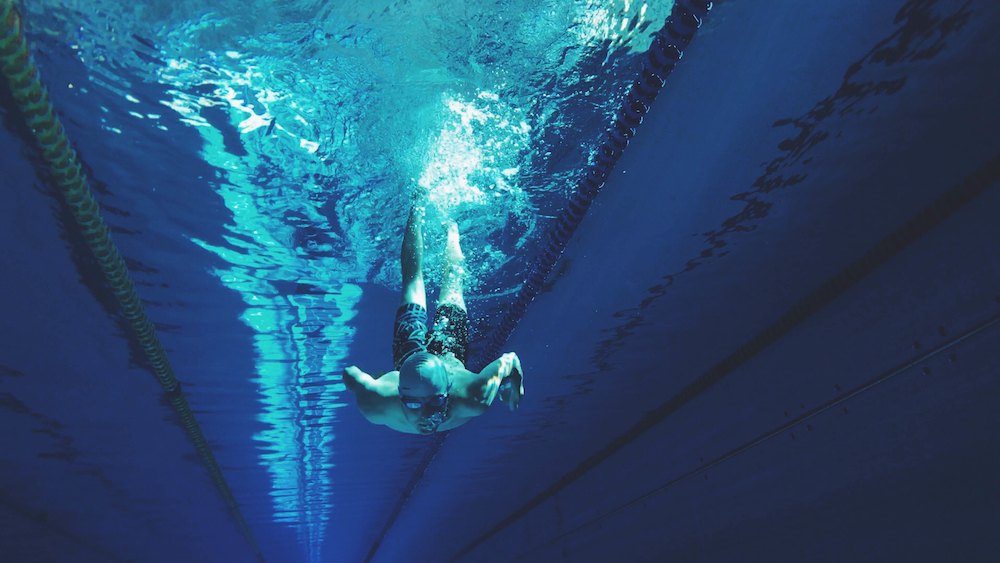 man diving into pool