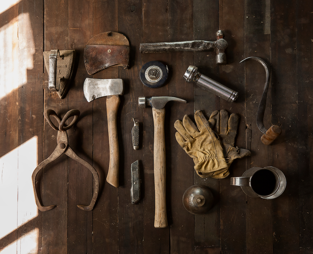 set of tools laid out in aerial view on hardwood surface