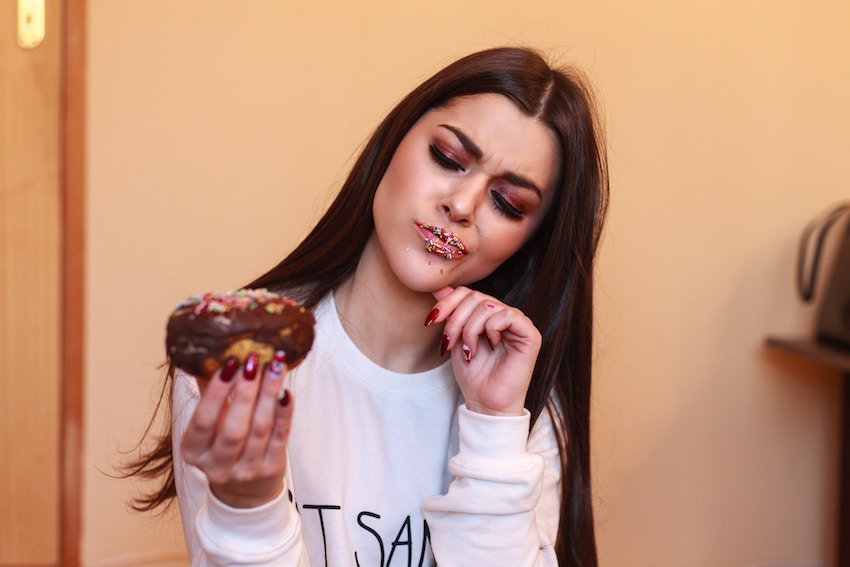 woman looking at a donut