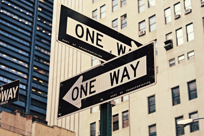 fork in the road with one way signs