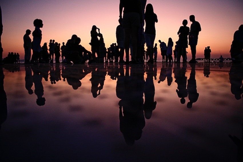 silhouettes of people on a beach