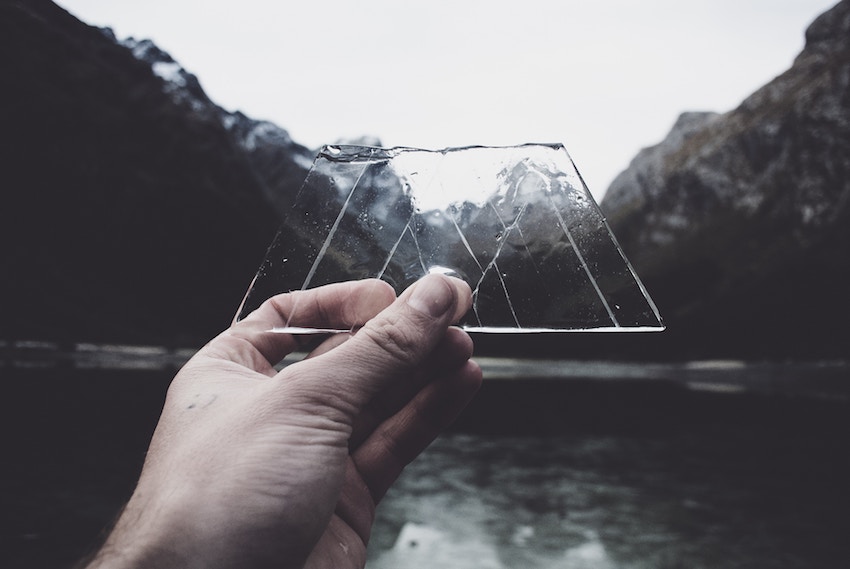 piece of ice held up over mountain