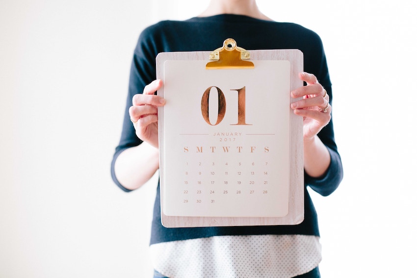 woman holding clipboard with calendar